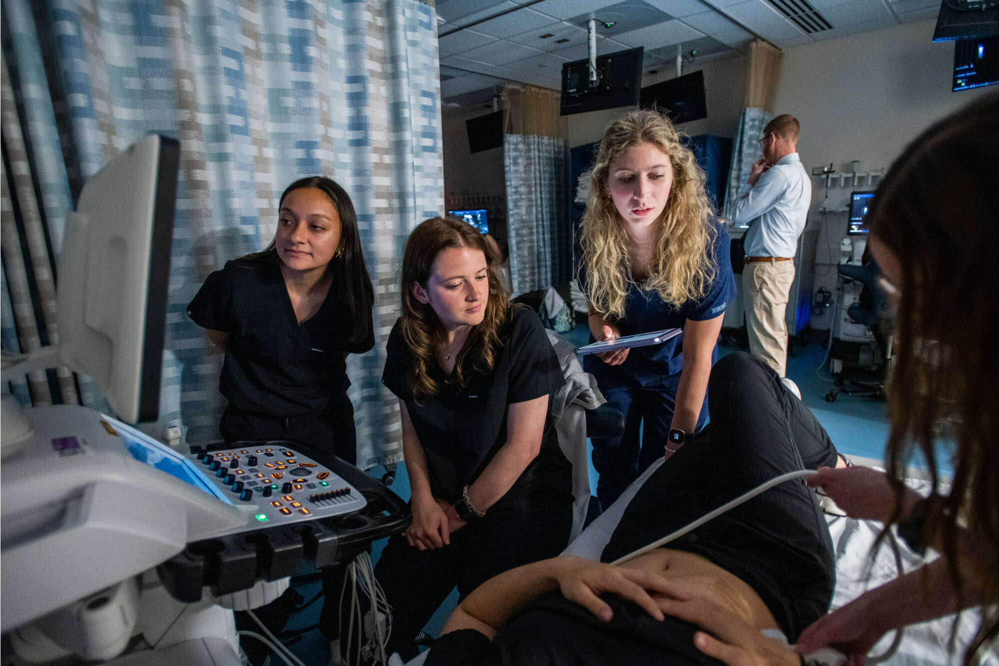 Clinical Applications III, combined lab with Traverse City in Allied Health SciencesFrom left, Laura Mascote, Emma Piasecki, Allison Smith, Julie Fagaly and “patient” on table is Elizabeth Hovest(Photo releases on file)